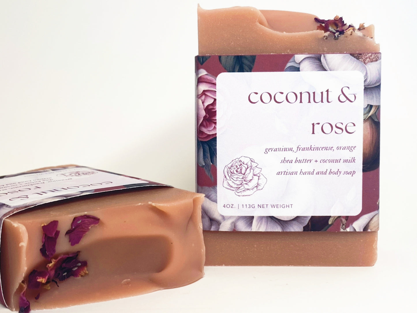 two bars of coconut and rose soap against a white backdrop