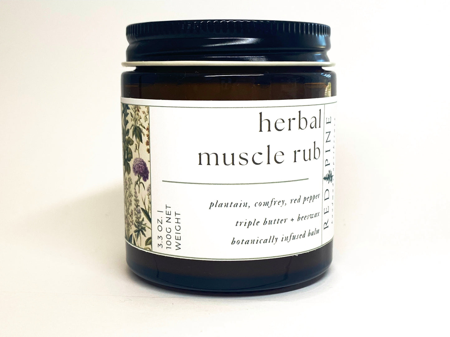 glass jar of herbal muscle rub against a white backdrop.