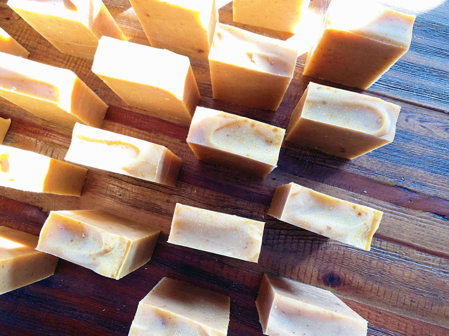 overhead view of 14 texas grapefruit soaps on a wooden table
