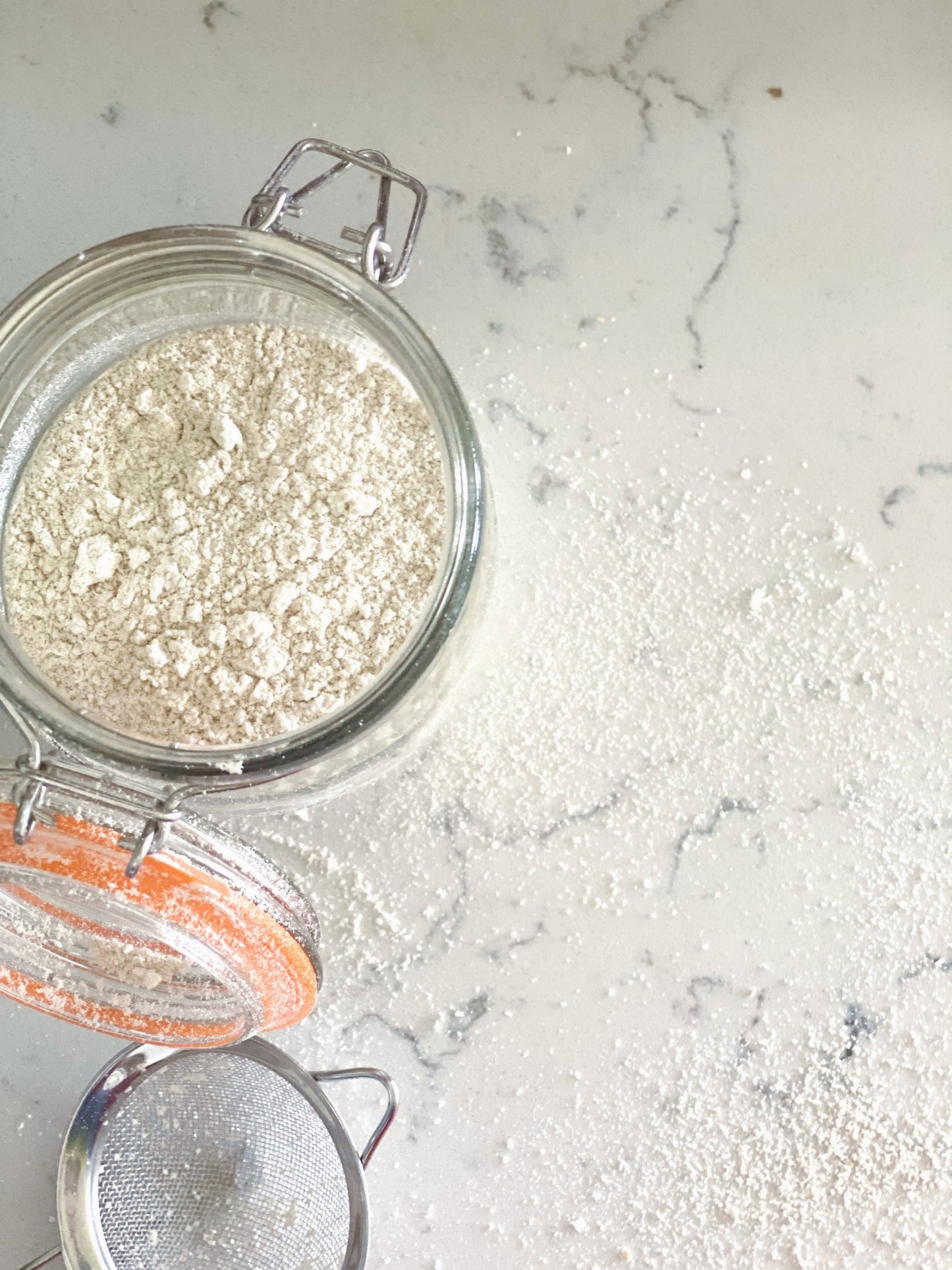 opened jar of colloidal oatmeal on a quartz countertop